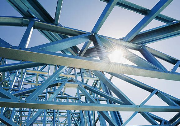 New home under construction using steel frames against a sunny sky.