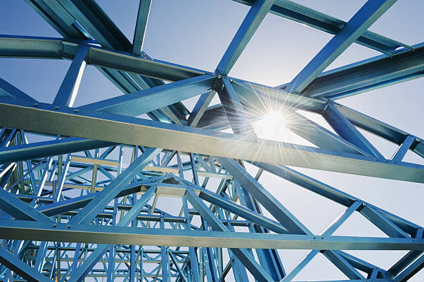 New home under construction using steel frames against a sunny sky. New home under construction using steel frames against a sunny sky.